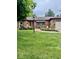 Charming brick home with a cozy front porch and professionally landscaped garden beds at 3130 Taylor Rd, Columbus, IN 47203