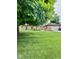 Traditional brick home featuring a well-manicured lawn and mature shade trees at 3130 Taylor Rd, Columbus, IN 47203