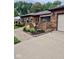 Brick home featuring a paved walkway, landscaped garden beds and an attached garage at 3130 Taylor Rd, Columbus, IN 47203