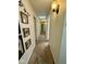 Well-lit hallway with carpet and decorative framed prints on the walls at 3130 Taylor Rd, Columbus, IN 47203