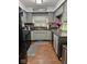 Updated kitchen with gray cabinets, granite countertops, and modern appliances at 3130 Taylor Rd, Columbus, IN 47203