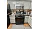 Galley kitchen shows gray cabinets, granite countertops and stainless steel microwave at 3130 Taylor Rd, Columbus, IN 47203