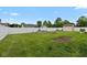 Green backyard with white fence, garden beds and space for gardening at 317 Virginia St, Fortville, IN 46040