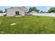 Wide green backyard with a patio and a white fence at 317 Virginia St, Fortville, IN 46040