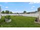 Lush backyard with garden beds, fire pit, and a white fence at 317 Virginia St, Fortville, IN 46040