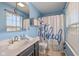 Bright blue bathroom with modern fixtures, decorative accents, and a window at 317 Virginia St, Fortville, IN 46040