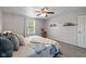 Bright bedroom with a comfortable bed, a ceiling fan, and window at 317 Virginia St, Fortville, IN 46040