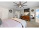 Large bedroom with ceiling fan, TV, and a decorative wall mirror at 317 Virginia St, Fortville, IN 46040