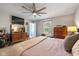 Well-lit bedroom with a TV, a dresser, and a comfortable bed at 317 Virginia St, Fortville, IN 46040