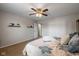 Cozy bedroom featuring neutral walls, carpet, and a ceiling fan with light, creating a warm and inviting atmosphere at 317 Virginia St, Fortville, IN 46040