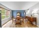 Traditional dining room featuring a wood table, buffet, and a blue accent wall illuminated by natural light at 317 Virginia St, Fortville, IN 46040