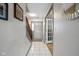 Bright hallway with neutral walls, tiled floor, stairs, and doorway featuring a white door with window panes at 317 Virginia St, Fortville, IN 46040