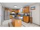 Spacious kitchen features light wood cabinets, stainless steel appliances, a functional island, and tile floors at 317 Virginia St, Fortville, IN 46040