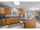 Functional kitchen with oak cabinets, an island, stainless steel appliances, and sliding doors leading to the patio at 317 Virginia St, Fortville, IN 46040