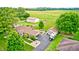 Wide aerial shot displays a home with a large barn and outbuildings, surrounded by greenery and open space at 333 N Windswept Rd, Greenfield, IN 46140