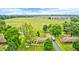 Expansive aerial view showcases a home with an RV parked in the driveway and open land behind it at 333 N Windswept Rd, Greenfield, IN 46140