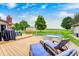 Inviting backyard featuring a wooden deck, a metal stock tank pool, and comfortable lounge seating at 333 N Windswept Rd, Greenfield, IN 46140