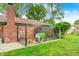 Brick home exterior featuring a fenced-in chicken coop in a well-maintained backyard at 333 N Windswept Rd, Greenfield, IN 46140