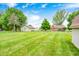 Expansive backyard featuring a lush lawn, storage shed, playset, and well-kept landscaping at 333 N Windswept Rd, Greenfield, IN 46140