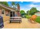 Relaxing backyard space featuring a wooden deck with an outdoor dining area and a comfortable rocking chair at 333 N Windswept Rd, Greenfield, IN 46140