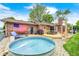 Picturesque backyard with a wooden deck, outdoor seating, a metal stock tank pool, and lush landscaping at 333 N Windswept Rd, Greenfield, IN 46140