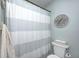 Clean bathroom with a shower featuring a gray and white striped shower curtain at 333 N Windswept Rd, Greenfield, IN 46140