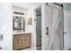 Bathroom featuring a wood vanity and a sliding barn door to the tiled shower at 333 N Windswept Rd, Greenfield, IN 46140