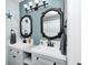 Dual sink bathroom with decorative mirrors, modern fixtures, and clean white countertops at 333 N Windswept Rd, Greenfield, IN 46140