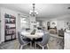 Inviting dining room features a decorative chandelier and seating for four at 333 N Windswept Rd, Greenfield, IN 46140