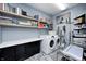 Clean laundry room with ample shelving, storage cabinets, a modern washer and dryer, and decorative flooring at 333 N Windswept Rd, Greenfield, IN 46140