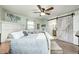 Bright main bedroom featuring a whitewashed wood sliding door to the en-suite bathroom at 333 N Windswept Rd, Greenfield, IN 46140