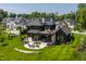 Stunning backyard featuring a patio with fire pit and seating, plus a deck with outdoor furniture and lush landscaping at 3675 Dartmoor Way, Zionsville, IN 46077