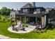 Expansive backyard featuring an outdoor kitchen, patio, and beautifully landscaped yard at 3675 Dartmoor Way, Zionsville, IN 46077