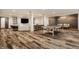 Spacious finished basement featuring a ping pong table, bar, and entertainment area with wood-look floors at 3675 Dartmoor Way, Zionsville, IN 46077