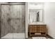 Bathroom featuring a walk-in shower with modern hardware, vanity with marble countertop, and framed mirror at 3675 Dartmoor Way, Zionsville, IN 46077
