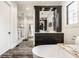 Bright bathroom features a freestanding tub, dark wood cabinets, and spa-like amenities at 3675 Dartmoor Way, Zionsville, IN 46077