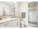 Bright bathroom with a glass shower and white cabinets with a marble countertop at 3675 Dartmoor Way, Zionsville, IN 46077