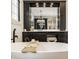 Elegant bathroom showcasing a freestanding tub, dark wood cabinetry, and high-end finishes at 3675 Dartmoor Way, Zionsville, IN 46077