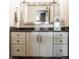 Bathroom vanity with white cabinets, black hardware, black countertop and stainless steel mirror at 3675 Dartmoor Way, Zionsville, IN 46077
