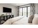 Comfortable bedroom featuring a large window and access to a private outdoor space at 3675 Dartmoor Way, Zionsville, IN 46077