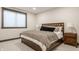 This bedroom features a queen size bed, modern window, and neutral paint for a relaxing atmosphere at 3675 Dartmoor Way, Zionsville, IN 46077