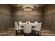 Elegant dining room features a round table with seating for six under a decorative chandelier and wainscoting at 3675 Dartmoor Way, Zionsville, IN 46077