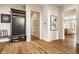 Inviting entryway with hardwood floors, custom mudroom cabinet and bench, and white trim at 3675 Dartmoor Way, Zionsville, IN 46077