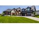 Beautiful home with stone and black accents, three-car garage and professionally landscaped yard at 3675 Dartmoor Way, Zionsville, IN 46077