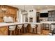 Well-lit kitchen with custom wood cabinetry, a spacious island, and modern appliances at 3675 Dartmoor Way, Zionsville, IN 46077