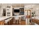 Kitchen with island seating, modern appliances and a custom bar area at 3675 Dartmoor Way, Zionsville, IN 46077