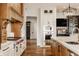 Well-lit kitchen with stainless steel appliances, custom cabinetry and a hardwood floor at 3675 Dartmoor Way, Zionsville, IN 46077