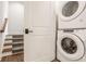 Convenient laundry area with a stacked washer and dryer and easy access to stairs at 3675 Dartmoor Way, Zionsville, IN 46077