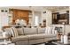 Inviting living room offering a view of the open-concept kitchen with custom wood detailing at 3675 Dartmoor Way, Zionsville, IN 46077