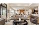 Open-concept living room with a large sofa and seamless transition to the kitchen area at 3675 Dartmoor Way, Zionsville, IN 46077